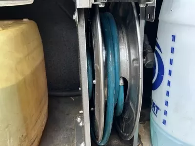 Internal hose reel installed inside Nilfisk SH Truck pressure washer cabinet protecting hose from frost damage.